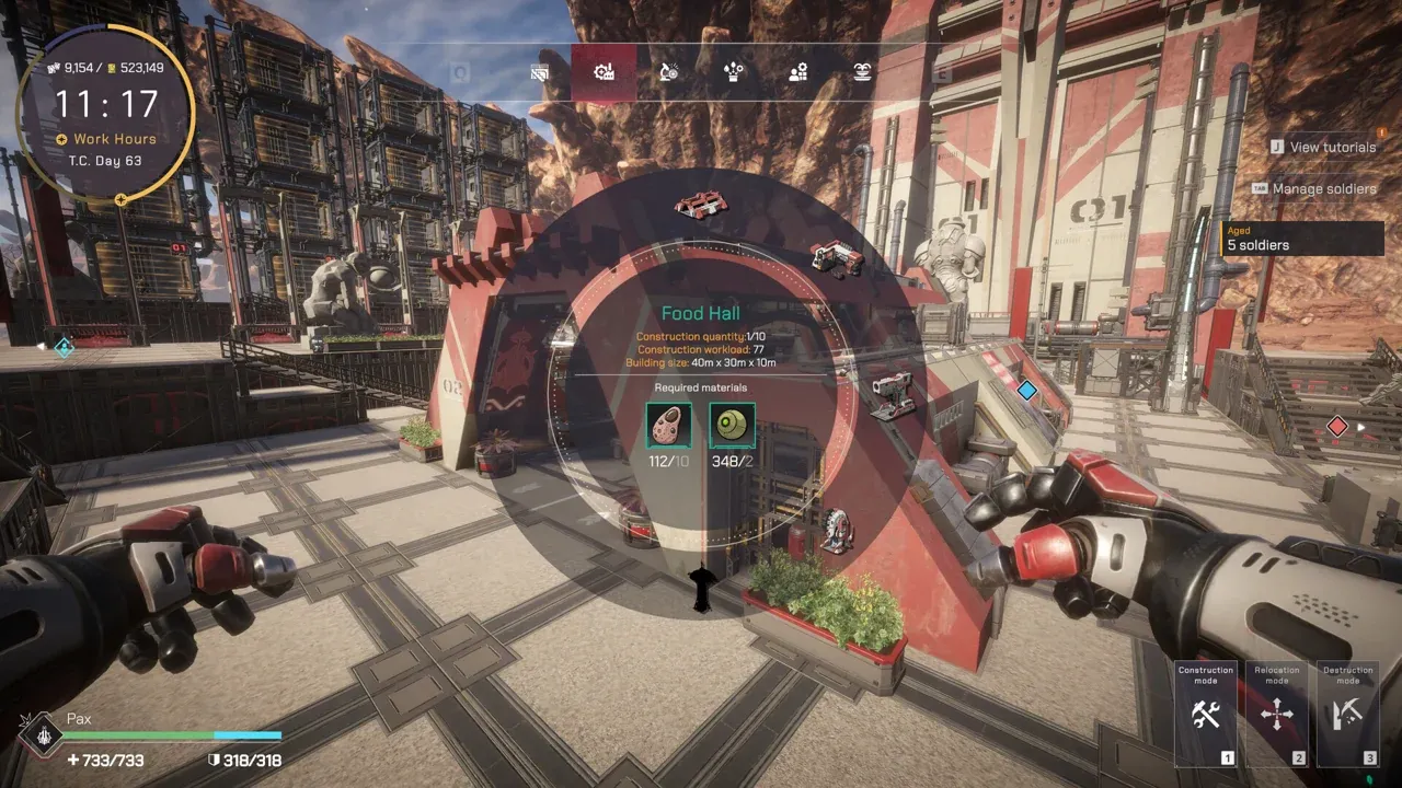 A Pax Autocratica town street with the red Food Hall gate and a soldier in the foreground